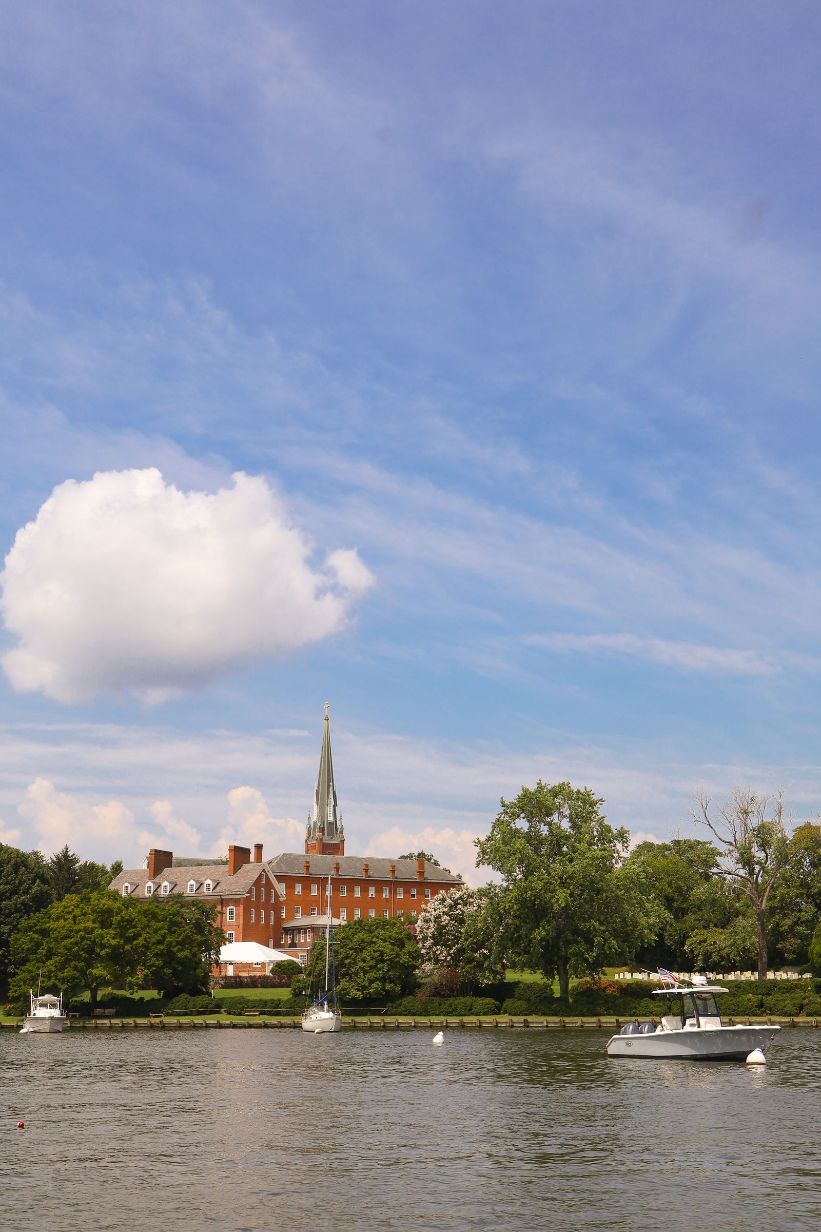 Sunny Annapolis waterfront with boats, trees, and a church steeple